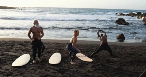 Multi generational surfer people doing warm up at the beach Stock Footage 151685210