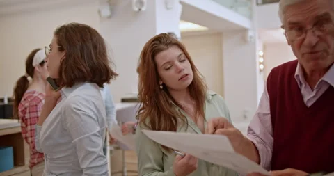 Multi generational team of people engaging in a collaborative brainstorm session Stock Footage 276922111