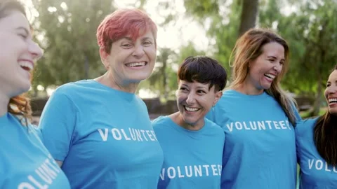 Multi generational team of volunteers hugging together  Stock Footage 245994378