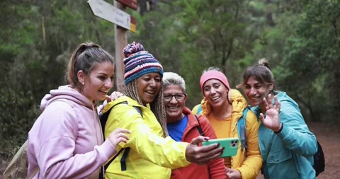 Multi generational women having fun during trekking day recording a video Stock Footage 164376794