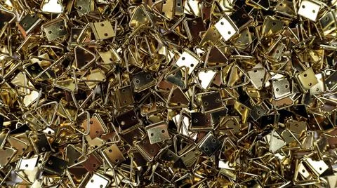 Multi gold plated triangle frame pendants with intricate texture scattered .. Stock Photos