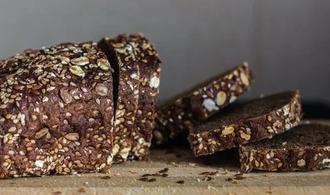 Multi grain board close up - Image. Black bread sliced ??on the background of Stock Photos