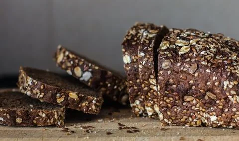 Multi grain board close up - Image. Black bread sliced ??on the background of Stock Photos