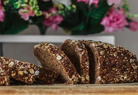 Multi grain board close up - Image. Black bread sliced ??on the background of Stock Photos