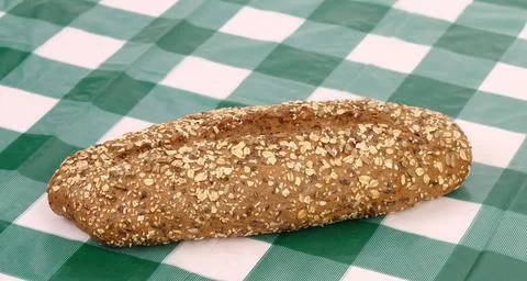  Multi - grain bread on a check tablecloth. Multi - grain bread on a check... Stock Photos