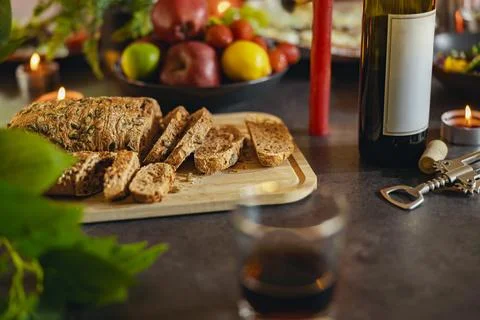 Multi grain cut bread with seeds on board is standing on festive table. Healthy Stock Photos