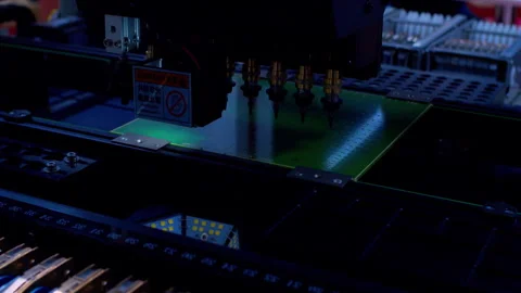 Multi-head automated machine assembling components on a modern PCB Stock Footage 337549817