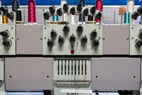 Multi head industrial sewing machine close up view inside small out of busine Fotos de archivo