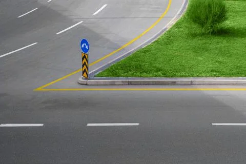 A multi-lane fork in the highway with road signs and lane markings, with an i Stock Photos