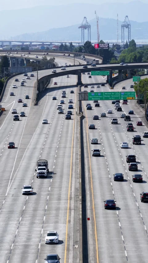 Multi-lane freeway interchange carries heavy commuter traffic near Oakland Stock Footage 340969098