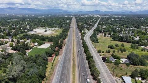 Multi-lane highway and parallel railway split suburban landscape, traffic Stock Footage 337745928
