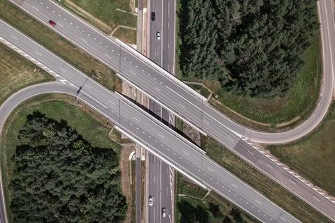 Multi-lane highway bridges over road in the countryside Stock Photos