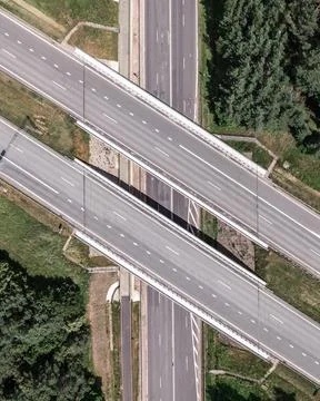 Multi-lane highway bridges over road in the countryside Stock Photos
