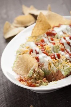 Multi-Layer Dip with Corn Tortilla Chips close up shot Stock Photos