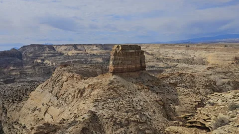 Multi layer rock tower in rugged canyon area-Pan Stock Footage 242438963