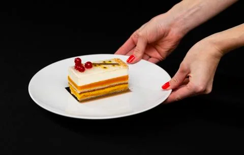 Multi layered beautiful cake with white cream and red currants, on a white pl Stock Photos