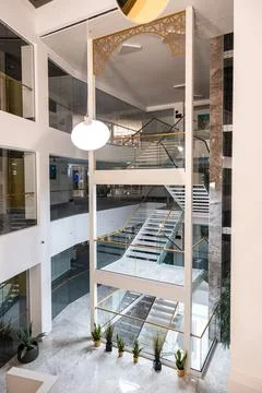 Multi level atrium with mirrored staircases and glass balustrades Stock Photos