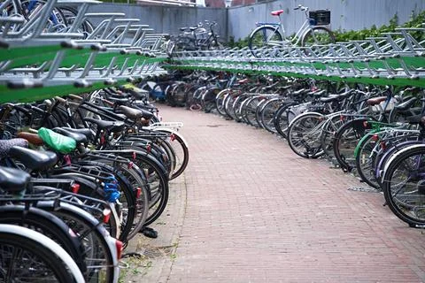 A multi-level bicycle parking facility with a large number of parked bicycles Stock Photos