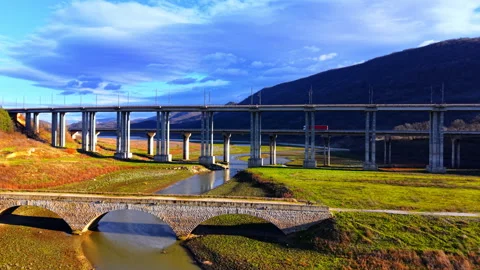 Multi level bridges and viaducts crossing valley under blue sky Stock Footage 333839122