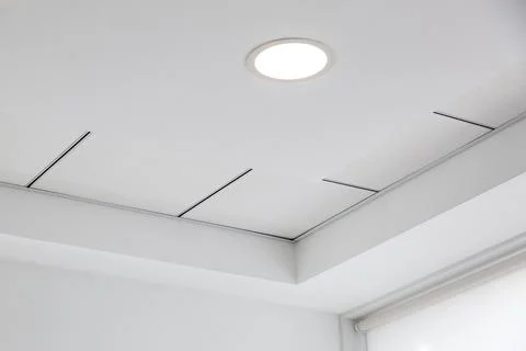 Multi-level ceiling with three-dimensional protrusions and suspended tiled. Stock Photos