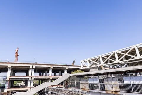 Multi level construction site with cranes and unfinished concrete building 스톡 사진