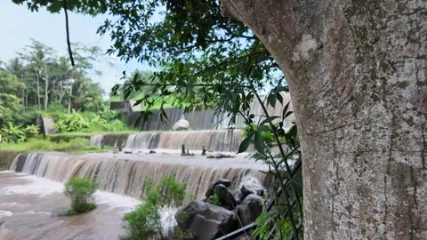 Multi-level dam on a river whose water is murky 스톡 동영상 291660442