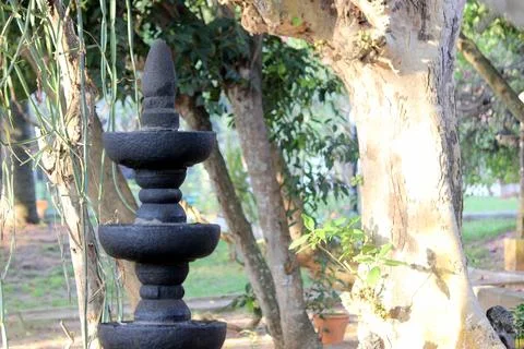Multi level Deep mala made of single black stone in middle of the garden with va Stock Photos