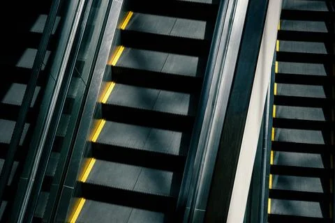 Multi-level escalators in modern shopping mall or airport Stock Photos