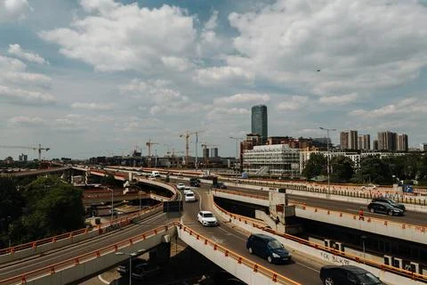 Multi level highway interchange with moving traffic and modern city construction Stock Photos