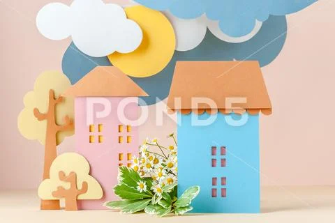 Multi-level installation of paper in children's style: Houses and flowers. Stock Photos