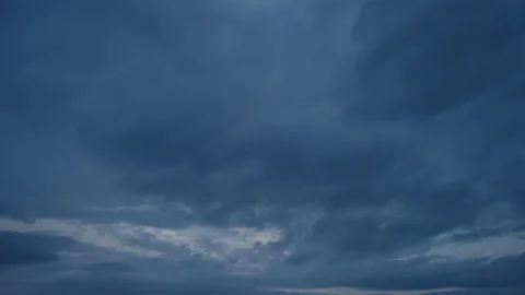 Multi-level layered clouds quickly sweep across the sky in opposite directions Stock Footage 226933337