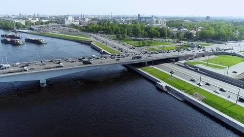 Multi-level road junction on near blue river with bridge and barges Stock Footage 91044817