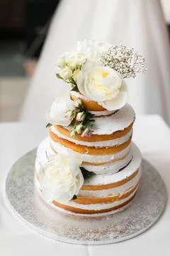 Multi level wedding cake with flowers Stock Photos