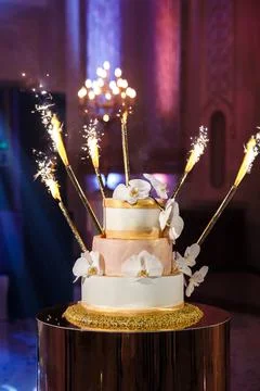 Multi level wedding cake with flowers and sparkles Stock Photos