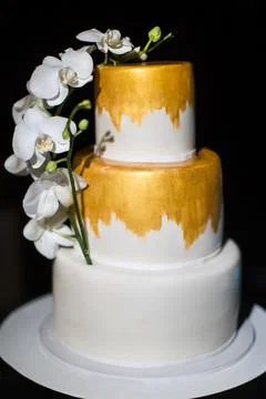 Multi level wedding cake with white orchids Stock Photos