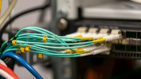 Multi-mode fiber optic patch cords plugged into a switch / router Stock Footage 122057423