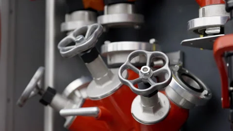 Multi-outlet valve for connecting fire hoses to water source Stock Footage 303888047