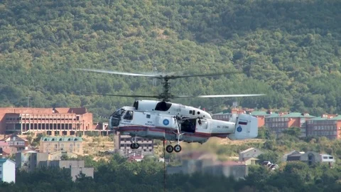 Multi-purpose helicopter Ka-32  hovering over waters of Gelendzhik Bay. Stock Footage 124578824