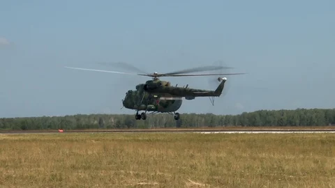 Multi-purpose helicopter Mi-8MTV (NATO : Hip) performs maneuvers over runway. Stock Footage 123210194