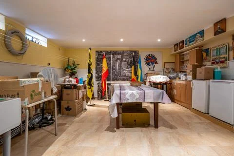 Multi purpose storage room interior with table shelves and boxes Stock Photos