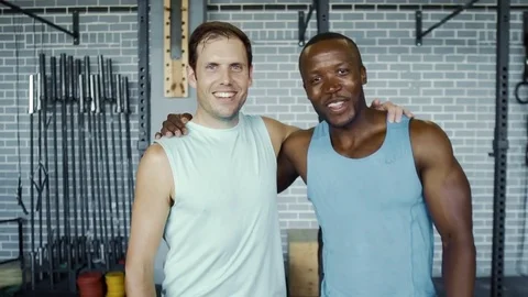 Multi racial friends smiling at camera in gym Stock Footage 71620740