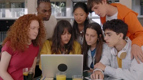 Multi-racial group of concentrates young students working in campus cafeteria Stock Footage 241260437