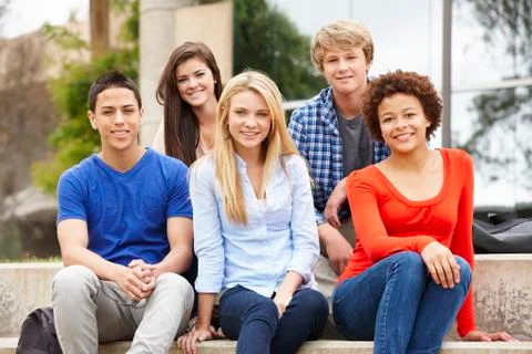 Multi racial student group sitting outdoors Stock Photos