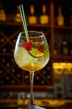 A multi-sensory cocktail featuring vibrant strawberries, lime, and mint in a Stock Photos