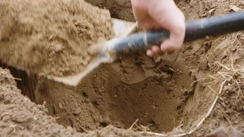 Multi Shot. Digging a Hole in the Mud with a Shovel Video stock 127990179