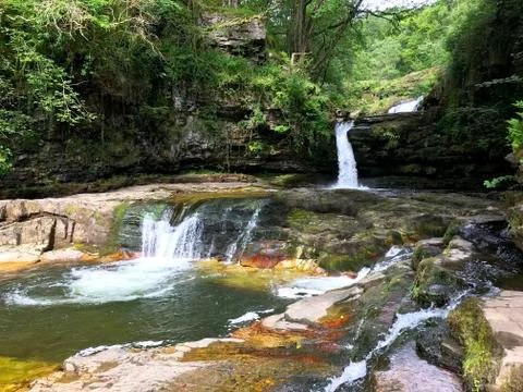Multi-step Waterfall Surrounded by Woodland Stock Photos