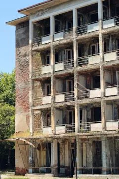 Multi-storey abandoned house without glass in the windows. Stock Photos