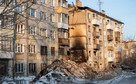 Multi-storey building after the explosion and fire. Entire hallway collapsed Stock Photos
