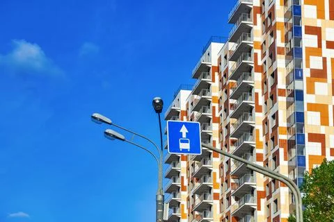 A multi-storey building against a blue sky. Beautiful sunny evening weather. Stock Photos