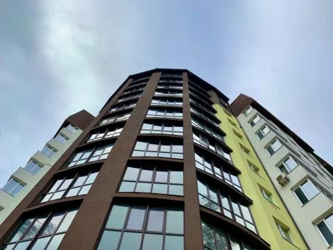 Multi-storey building on a background of blue sky. Tall building with mirrore Stock Photos